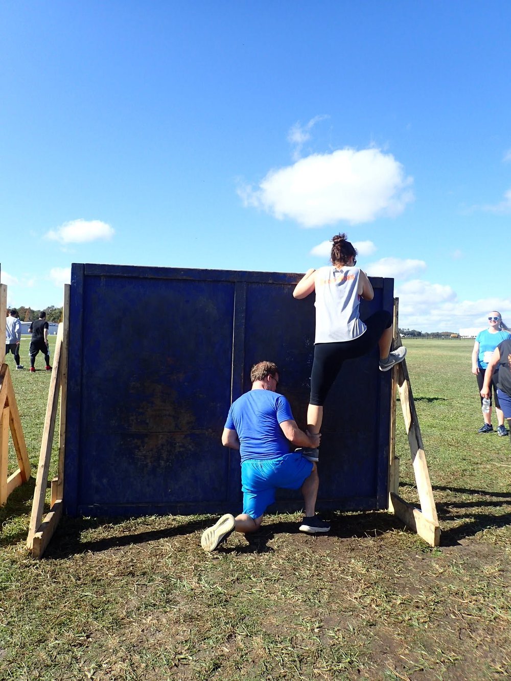 Assisting a client over a wall obstacle