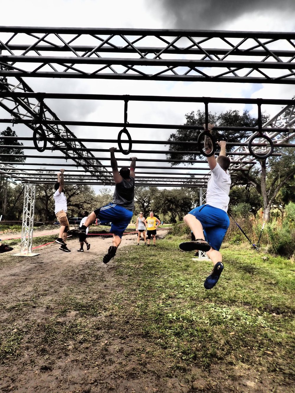Team crossing the monkey bars obstacle